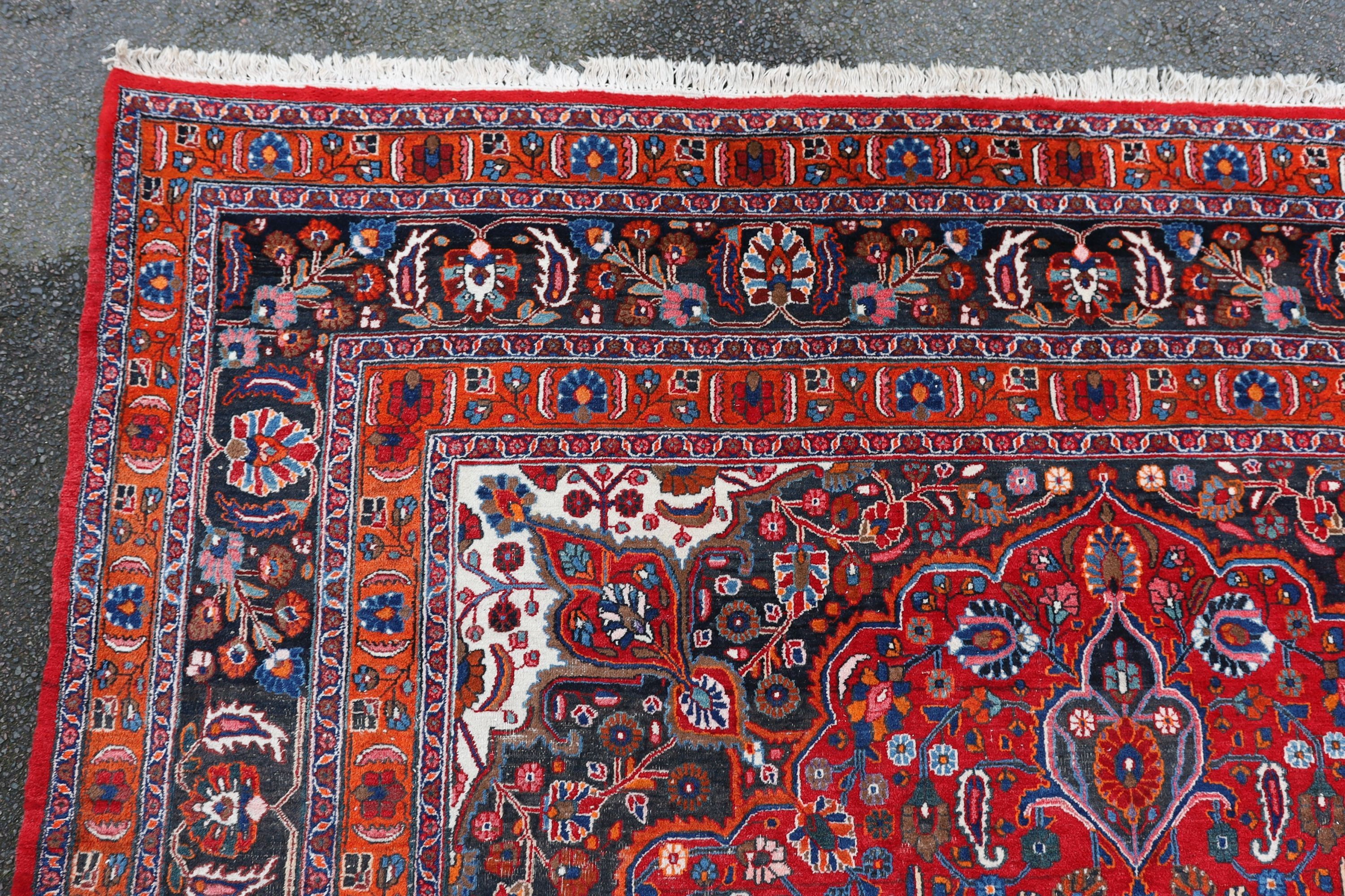 A Tabriz red ground carpet 422 x 326cm.